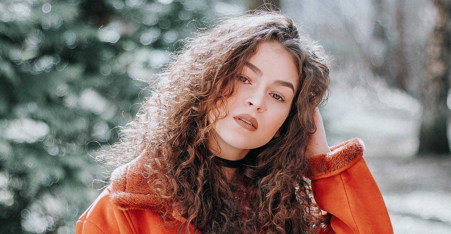 A clear image of a woman wearing red sharpened by Fotor's image sharpener