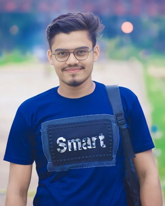 a man in blue shirt wearing a pair of glasses