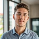 a man wearing a blue shirt with his back to the window
