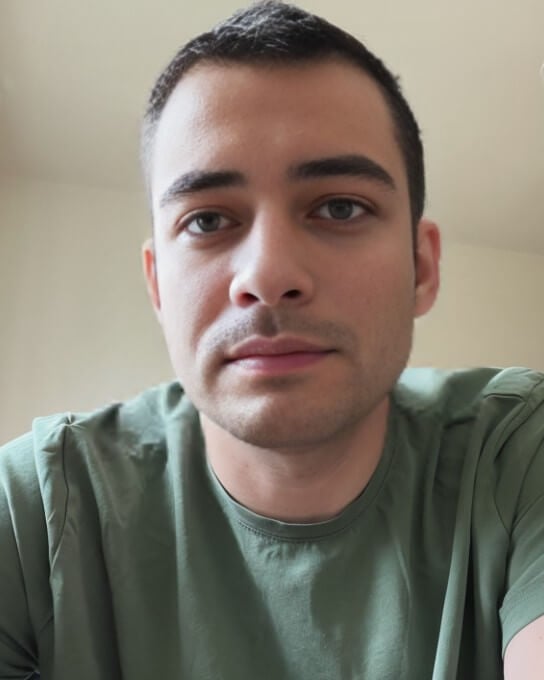 a man wearing a dark green tshirt