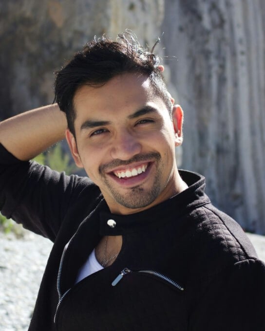 a smiling man in black casual outfit 