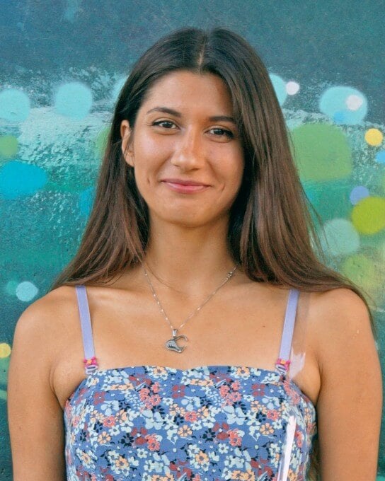 a woman with long hair wearing the blue slip dress 