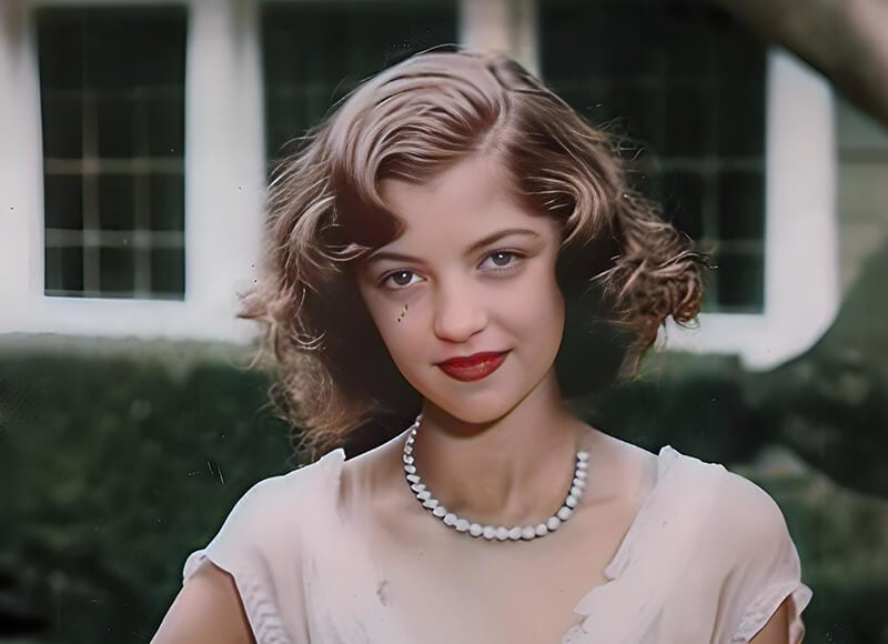 Black and white portrait of a woman colorized with realistic and natural colors using Fotor AI black and white to color photo converter